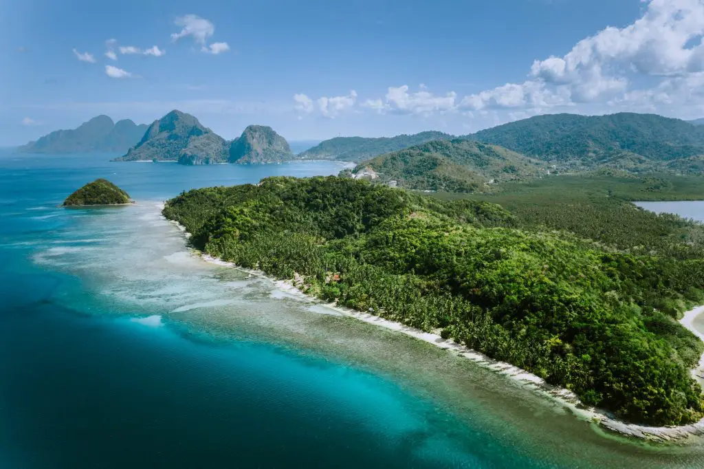 Aerial panoramic view of Palawan amazing coastline, majestic limestone cliffs and sea bay in El Nido