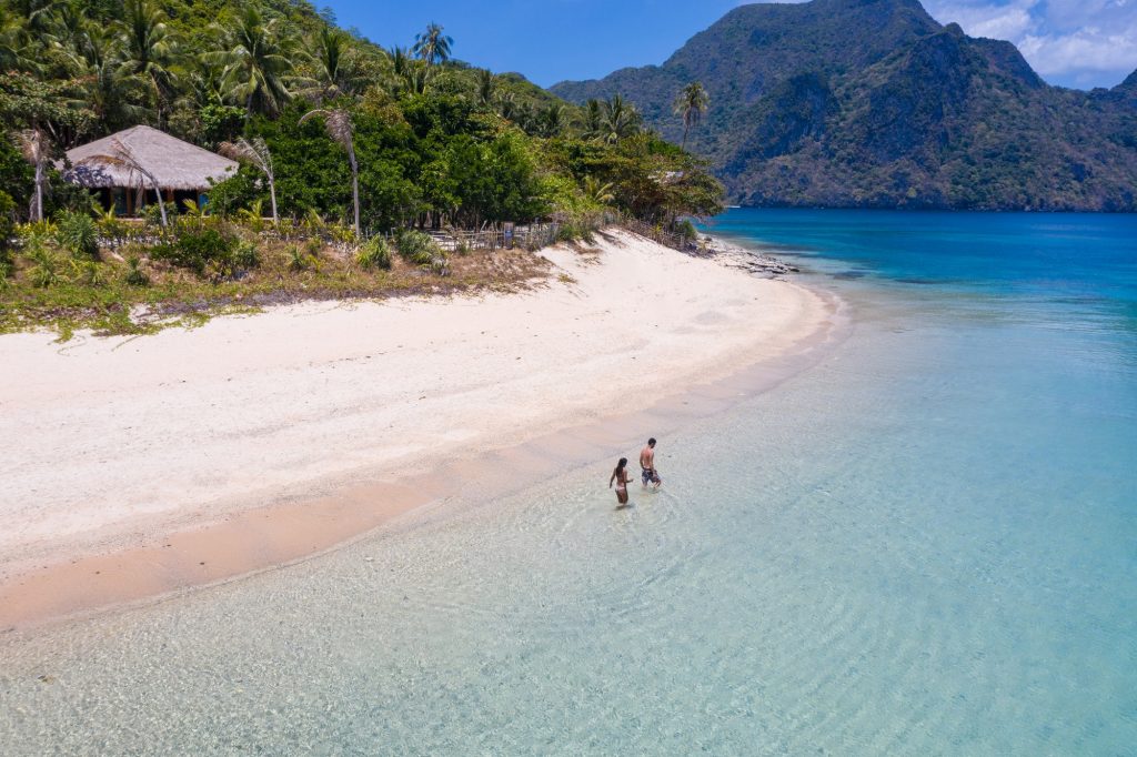 Couple on a tropical beach in El Nido, Palawan, Philippines