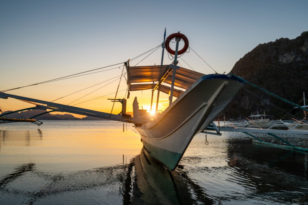 Tropical harbor bay in evening. Golden hour in lagoon in Philippines, Palawan, El Nido. Sunset on