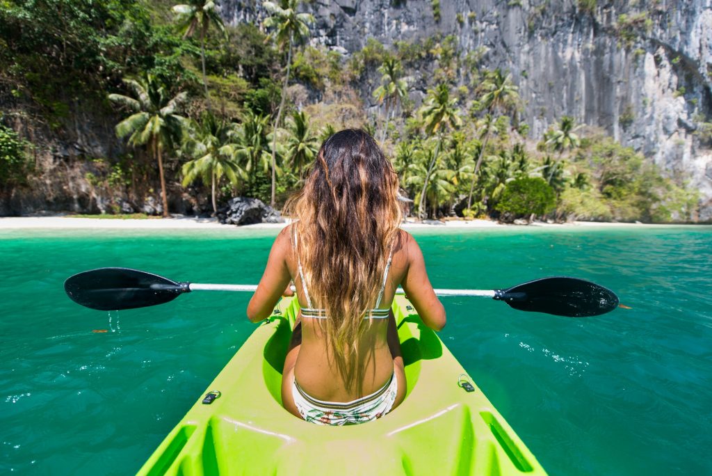 Woman kayaking in the Small Lagoon in El Nido , Philippines