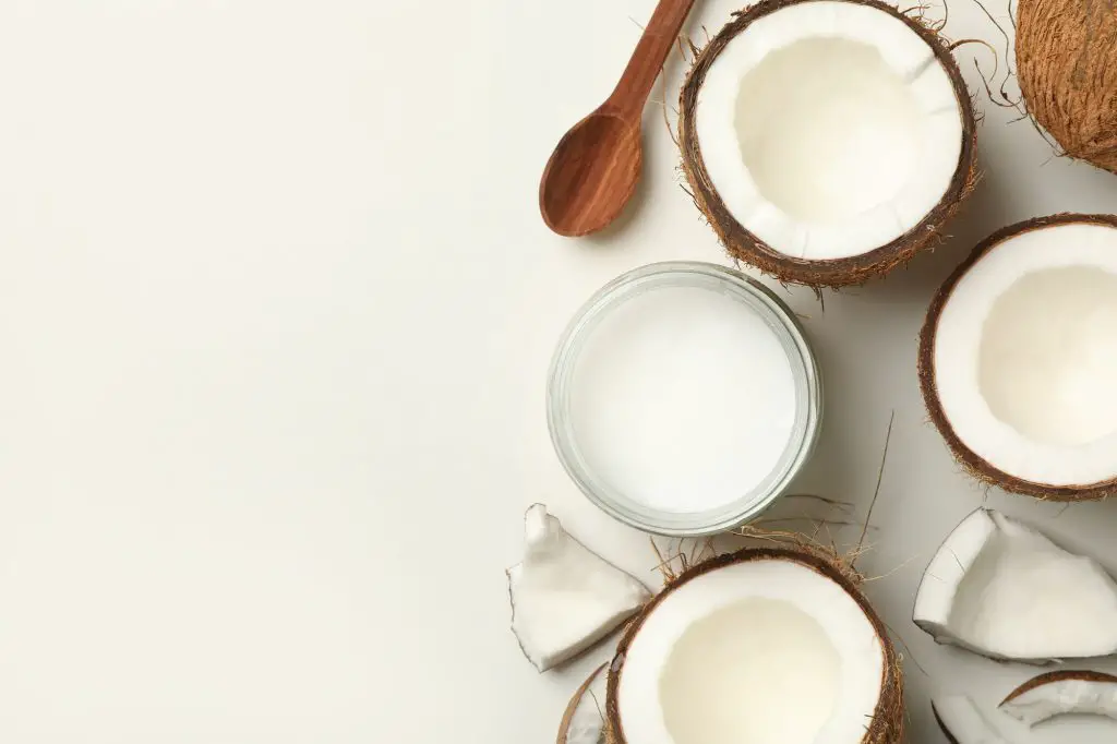 Fresh coconut and coconut milk on white background