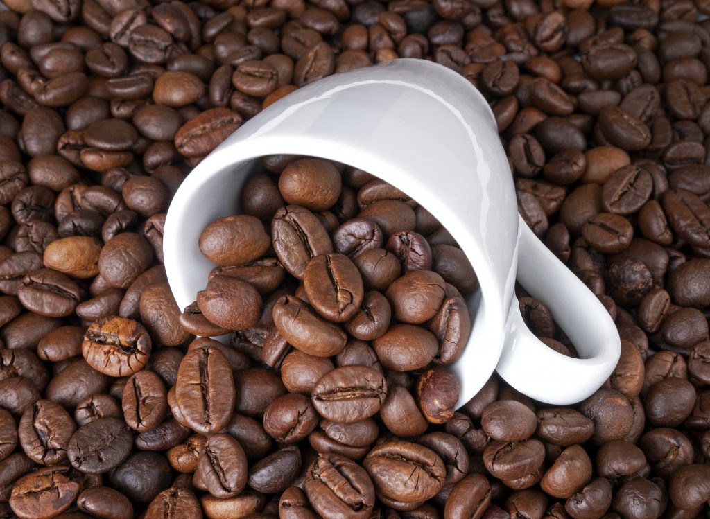 Cup of coffee full of coffee beans